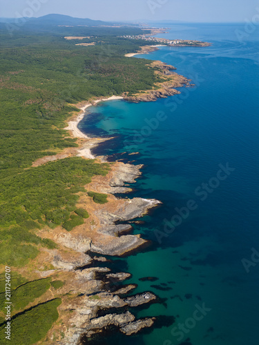 Aerial Top-Down View of Rocky Coastline and Deep Blue Sea Water