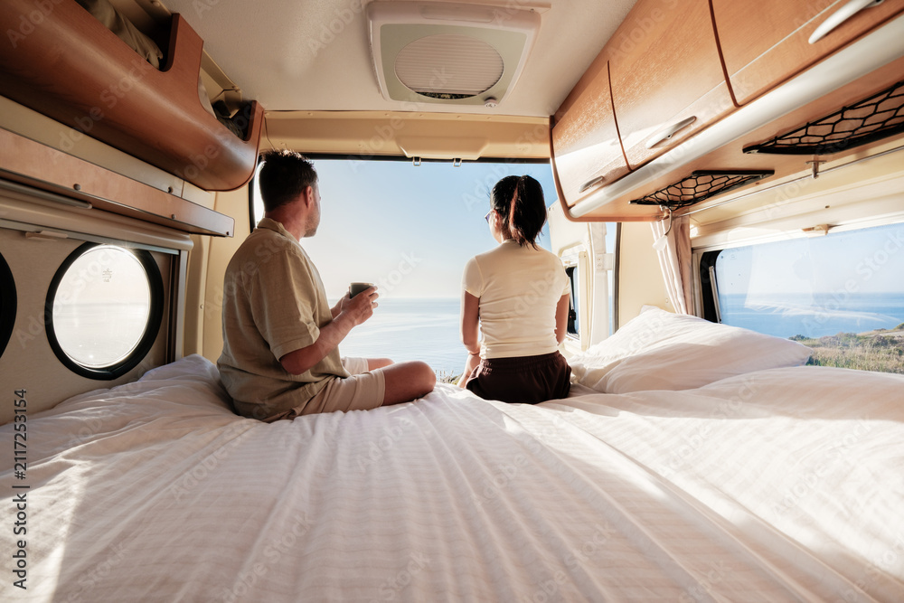 Obraz premium Couple enjoying a serene morning view in a van overlooking Chalkidiki's stunning coastline