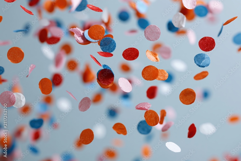 Obraz premium The Confetti Celebration in the Air: Colorful Circles Dancing Across Blue