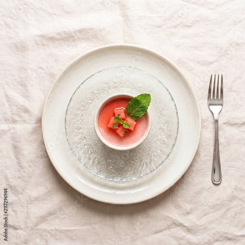 A small bowl of fresh watermelon mousse with mint garnish