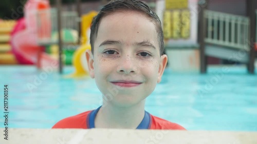 Smiling 10 Year Old Boy Portrait Looking at Camera in Swimming Pool