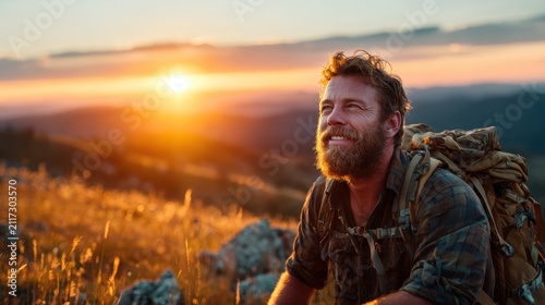 A smiling man takes in the serene beauty of a sunset while surrounded by nature, exemplifying peace and contentment in a tranquil landscape of golden hour light.