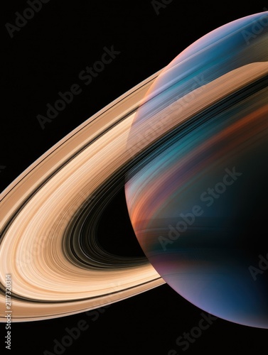 Swirling, colorful planetary rings encircle a dark, banded sphere against black