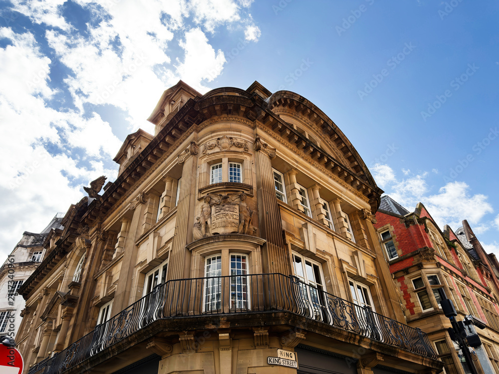 Obraz premium Historic neoclassical building facade with balcony and ornate stone details on King Street, Manchester, UK