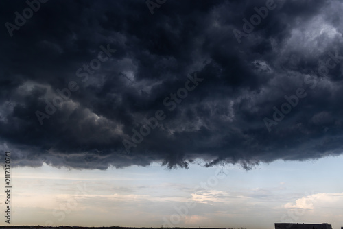 Dark storm clouds over horizon with dramatic weather transformation