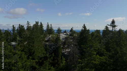 Aerial view of dense coniferous forest and rocky outcrops in Koli National Park in Koli, Pohjois-Karjala, Finland.