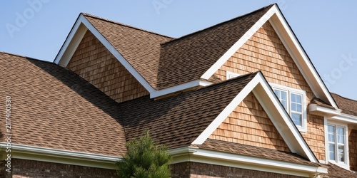 Architectural shingles and cedar shakes adorn a suburban home's gabled roof