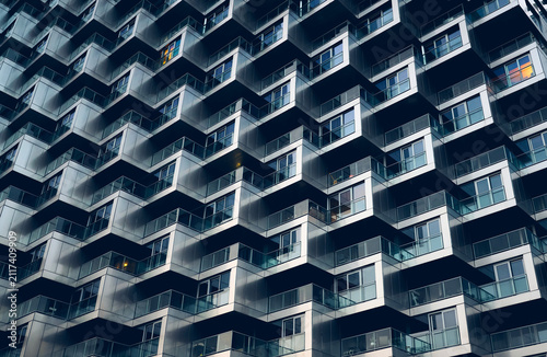 Abstract architectural background of modern skyscraper geometric facade pattern with metallic balconies and windows of Vancouver House, Vancouver, British Columbia, Canada.
