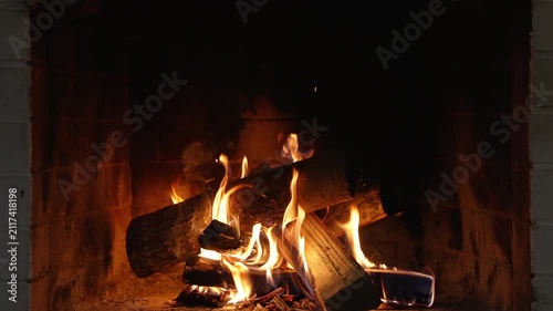Fire Burning in Fireplace. Flames Engulf a Firelighter Nestled Among Charcoals in a Cozy Fireplace, Creating a Warm and Inviting Atmosphere Perfect for Winter Celebrations and Festive Gatherings