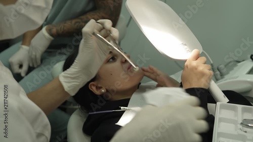 Dental specialist performing orthodontic procedure on patient