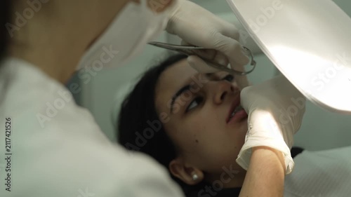 Orthodontist performing braces treatment on a patient