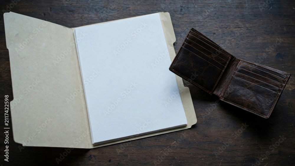 Fototapeta premium Open Notebook and Wallet on Dark Textured Surface.