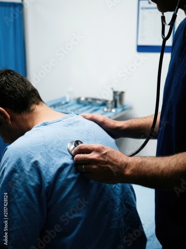 Doctor Checking Patient's Lungs With Stethoscope During Medical Examination