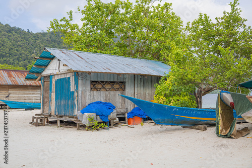 The beach scene with boat under palm tree