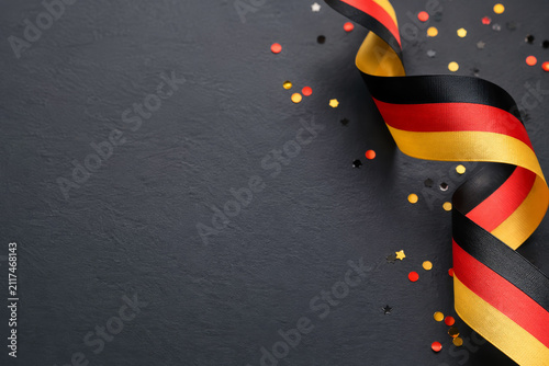 Constitution Day in Germany greeting card concept with flag ribbon and confetti.