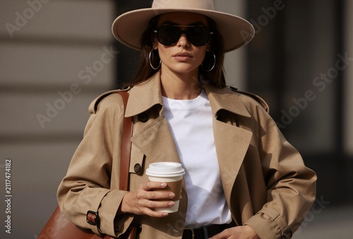 Chic Woman in Trench Coat Holding Coffee Cup