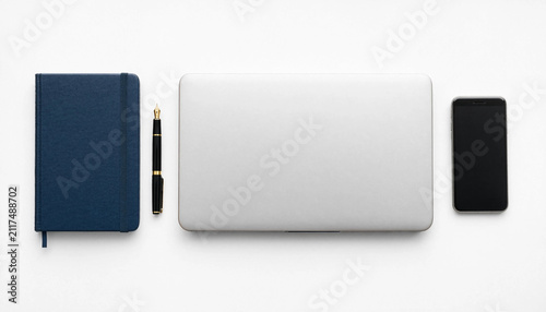 Closed laptop with blue notebook pen and smartphone on a desk top view