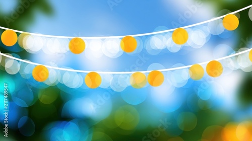 Strings of glowing yellow lights hang outdoors amid a blurred, vibrant blue and green bokeh background