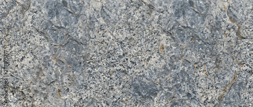 Cuadro en lienzo Granite rock texture featuring a rugged, weathered surface of light grey, white,