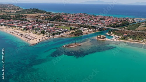 Nea Potidea coastline with turquoise sea and seaside village