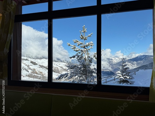 Beautiful winter landscapes of the Austrian Alps featuring snow-covered mountain villages, alpine houses, forests, panoramic mountain views, and clear blue skies after snowfall. Ideal for travel