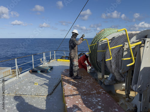 Commercial shipping crew preparing for docking and berthing