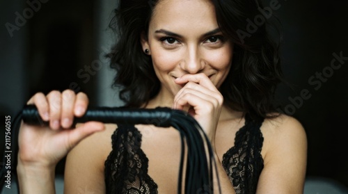 Woman in Lingerie Holding a Whip with a Playful Expression