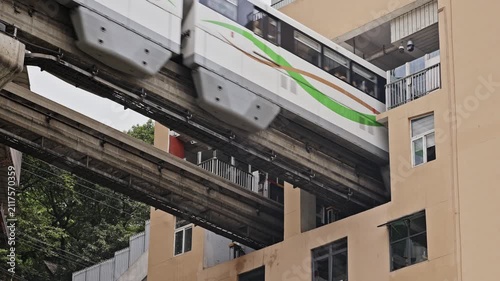 train enters liziba station inside a building on bridge in Chongqing china