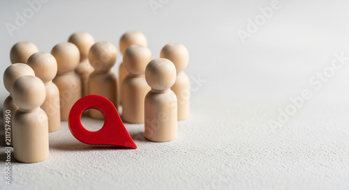 Red location pin placed among wooden figures, perfect for targeting specific audience mapping location and market group finding