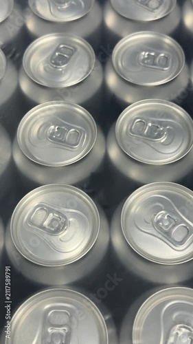 Rows of sealed aluminum cans are grouped in multipacks, creating a clean commercial display suitable for wholesale supply, retail sales and beverage distribution. Close up.