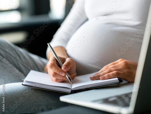 Close-up of a Pregnant Woman Taking Notes During an Online Consultation With a Healthcare Professional in Natural Light