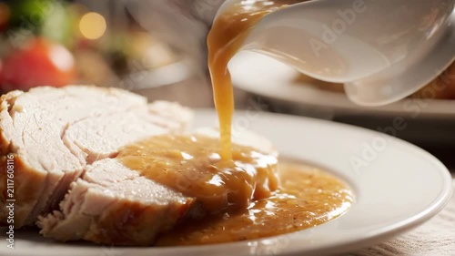 Delicious Gravy Poured Over Sliced Turkey Breast for a Festive Holiday Meal.
