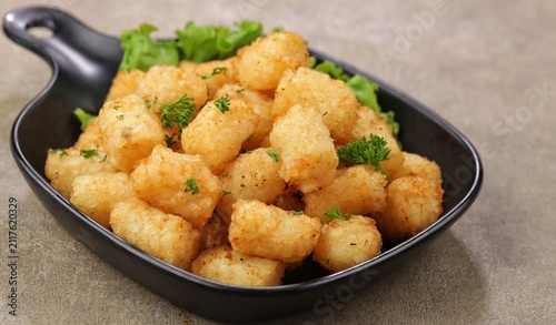 Quadro su tela Delicious fried potatoes known as tater tots or pom pom potato