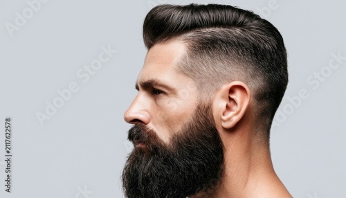 Side view of a man with a trendy haircut and a full beard