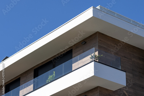 modern apartment building corner detail with glass balcony