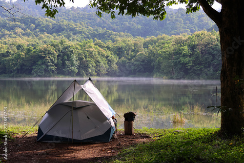 Camping on a holiday, compact in size, near a small lake with light morning mist