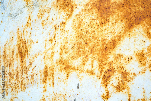 Textured rusty metal background with white paint peeling