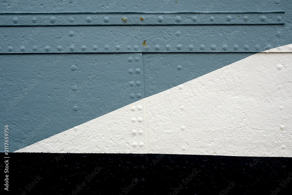Fototapeta premium Weathered painted metal panels in blue grey and white form a diagonal geometric composition