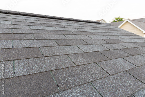 Asphalt Shingle Roof Texture, A close-up view of a dark gray asphalt shingle roof showing the granular texture and overlapping pattern