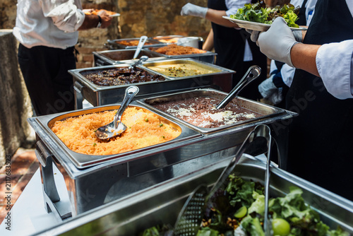 Catering staff serving Mexican food at an event buffet in Mexico Latin America, plate of mexican rice and sauces 