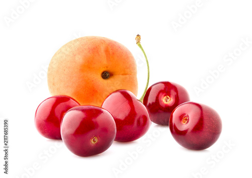 Sweet cherries with apricot isolated on white background cutout. Ripe berries closeup.