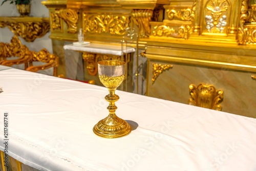 Obraz na płótnie Golden chalice standing on altar during religious ceremony