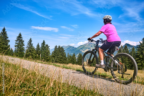 Active senior woman riding ...