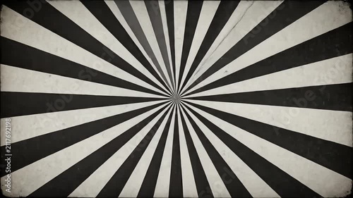 Dynamic black and white spinning sunburst pattern with vintage grunge paper texture
