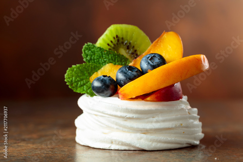 Pavlova dessert with nectarines, kiwis, blueberries, and mint.