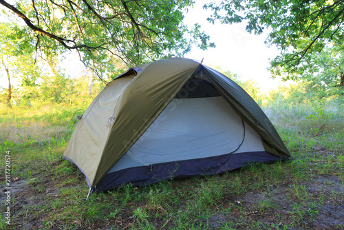 Camping tent set up in a serene natural environment