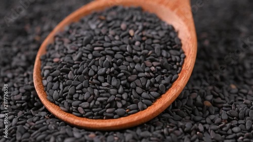 Black Sesame Seeds in Wooden Spoon