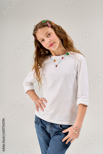 Canvas Print Charming young girl in stylish comfy attire strikes a playful pose