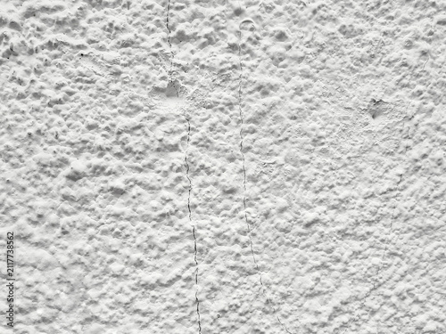 Konstfotografi Background of a rough white stucco wall textured with natural vertical fine cracks