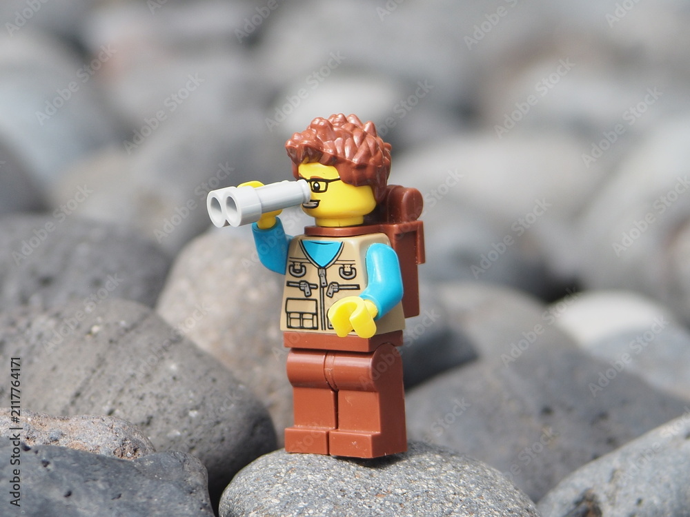 Fototapeta premium Indonesia - January 25, 2025 : Mini toy of action figure at outdoor with blurred background. Toy photography concept design. Minifigure of people character traveling and trekking at mountain